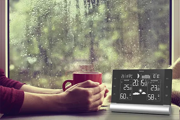The weather station is on the windowsill.