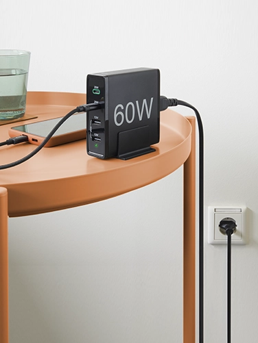 Smartphone lies on a table and charges via Hama 4 Ports Quick Charger, 2x USB-C PD / QC, 2x USB-A, 60 W