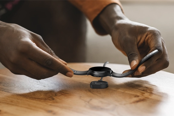 The smartwatch is charged via the magnetic charging cradle