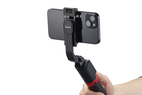 Cropped image of a hand using the "Fancy Stand 70 II" tripod as a selfie stick